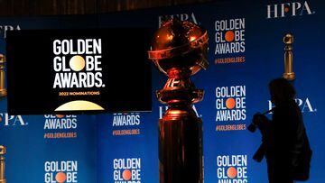 FILE PHOTO: A person holds a camera next to the Golden Globe statue before the 79th Annual Golden Globe Awards nominations announcement in Beverly Hills, California, U.S., December 13, 2021. REUTERS/Mario Anzuoni/File Photo