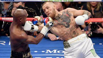 LAS VEGAS, NV - AUGUST 26: Conor McGregor (R) throws a right at Floyd Mayweather Jr. in the second round of their super welterweight boxing match at T-Mobile Arena on August 26, 2017 in Las Vegas, Nevada. Mayweather won by 10th-round TKO.   Ethan Miller/Getty Images/AFP == FOR NEWSPAPERS, INTERNET, TELCOS &amp; TELEVISION USE ONLY ==