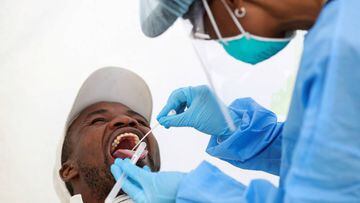FILE PHOTO: A medical worker wearing personal protective equipment (PPE) takes a swab sample from a man, as South Africa starts to relax some aspects of a stringent nationwide coronavirus disease (COVID-19) lockdown in Diepsloot near Johannesburg, South A