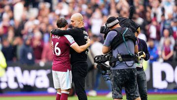 Manchester City manager Pep Guardiola hugs West Ham United's Mark Noble at the end of the Premier League match at London Stadium, London. Picture date: Sunday May 15, 2022. (Photo by Adam Davy/PA Images via Getty Images)