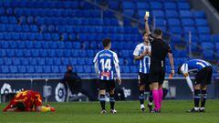 BARCELONA, SPAIN - NOVEMBER 29: The referee Juan Luis Pulido Santana shows a yellow card to Lluis Lopez of RCD Espanyol during the La Liga Smartbank match between RCD Espanyol and Real Zaragoza at RCDE Stadium on November 29, 2020 in Barcelona, Spain. (Ph
