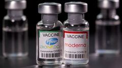 FILE PHOTO: Vials with Pfizer-BioNTech and Moderna coronavirus disease (COVID-19) vaccine labels are seen in this illustration picture taken March 19, 2021. REUTERS/Dado Ruvic/File Photo