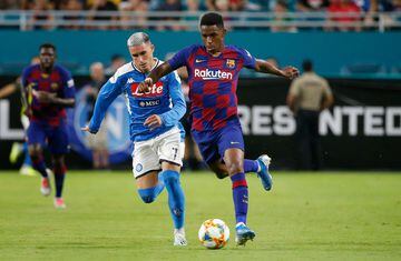 Napoli's Jose Callejon (L) vies for the ball against Barcelona's Junior Firpo (R) during the International Champions Cup football match between FC Barcelona and SSC Napoli at Hard Rock Stadium in Miami, Florida, on August 7, 2019. 