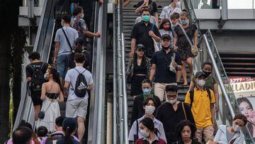 BANGKOK, THAILAND - 2022/07/05: People wearing face masks as a preventive measure against the spread of covid-19 use an escalator in front of the Central World in Bangkok, Thailand. (Photo by Peerapon Boonyakiat/SOPA Images/LightRocket via Getty Images)