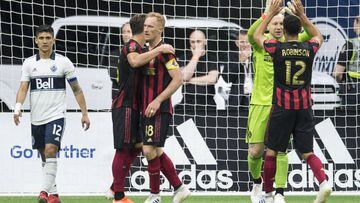 Atlanta United players celebrate a 1-0 win over the Vancouver Whitecaps during an MLS soccer match Wednesday, May 15, 2019, in Vancouver, British Columbia. (Jonathan Hayward/The Canadian Press via AP)