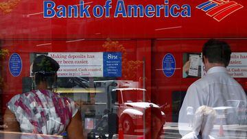 FILE PHOTO: Pedestrians are reflected in the window as customers conduct transactions at a Bank of America ATM in Washington July 19, 2011.   REUTERS/Kevin Lamarque/File Photo