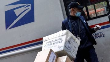 FILE PHOTO: FILE PHOTO: A United States Postal Service (USPS) worker unloads packages from his truck in Manhattan during the outbreak of the coronavirus disease (COVID-19) in New York City, New York, U.S., April 13, 2020. REUTERS/Mike Segar/File Photo/Fil