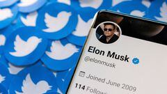 Elon Musk's Twitter profile is seen on a smartphone placed on printed Twitter logos in this picture illustration taken April 28, 2022.