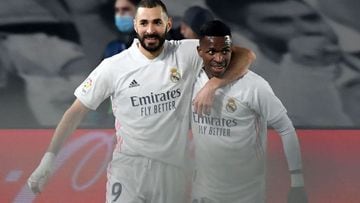 Real Madrid&#039;s French forward Karim Benzema (L) celebrates his goal with Real Madrid&#039;s Brazilian forward Vinicius Junior during the Spanish league football match between Real Madrid CF and Granada FC at the Alfredo di Stefano stadium in Valdebeba