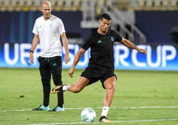 Real Madrid coach Zinedine Zidane looks on as Cristiano Ronaldo shoots on goal during training in Skopje.
