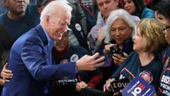 In this file photo Democratic presidential hopeful and former Vice President Joe Biden takes a selfie with supporter Margarita Rebollal after speaking at a Nevada Caucus watch party on February 22, 2020, in Las Vegas, Nevada.