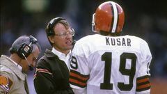 CLEVELAND, OH - CIRCA 1980&#039;s:  Head Coach Marty Schottenheimer of the Cleveland Browns talks with his quarterback Bernie Kosar #19 on the sidelines during a mid circa 1980&#039;s NFL football game at Cleveland Municipal Stadium in Cleveland, Ohio. Schottenheimer was the head coach of the Cleveland Browns from 1984-88. (Photo by Focus on Sport/Getty Images)