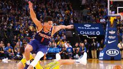 Mar 10, 2019; Oakland, CA, USA; Phoenix Suns guard Devin Booker (1) trips over Golden State Warriors guard Klay Thompson (11) chasing a loose ball during the fourth quarter at Oracle Arena. Mandatory Credit: Kelley L Cox-USA TODAY Sports
