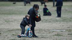 A woman helps her kid to ride a tricycle at a park during a national holiday as the number of the coronavirus disease (COVID-19) infections decreases , in Buenos Aires, Argentina June 21, 2021. REUTERS/Agustin Marcarian