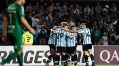 Argentina's Racing Carlos Alcaraz (covered) celebrates with teammates after scoring a goal against Brazil's Cuiaba during their Copa Sudamericana group stage first leg football match at the Presidente Juan Domingo Peron stadium in Buenos Aires, on April 13, 2022. (Photo by ALEJANDRO PAGNI / AFP) (Photo by ALEJANDRO PAGNI/AFP via Getty Images)