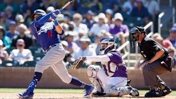 SCOTTSDALE, ARIZONA - MARCH 24: AJ Pollock #11 of the Los Angeles Dodgers hits a solo home run against the Colorado Rockies during the third inning of the MLB spring training game at Salt River Fields at Talking Stick on March 24, 2022 in Scottsdale, Ariz