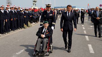 French President Emmanuel Macron and French WWII veteran of the Commando Kieffer Leon Gautier leave a ceremony in tribute to the 177 French members of the "Commando Kieffer" Fusiliers Marins commando unit who took part in the Normandy landings.