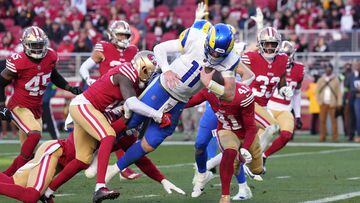 Los Angeles Rams quarterback Carson Wentz (11) dives for a touchdown against San Francisco 49ers cornerback Samuel Womack III (left) and safety Tayler Hawkins (41).
