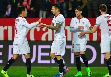 Sevilla's midfielder Vitolo (L) celebrates with teammates after scoring during the Spanish league football match Sevilla FC vs SD Eibar on February 18, 2017.  Sevilla won 2-0.
