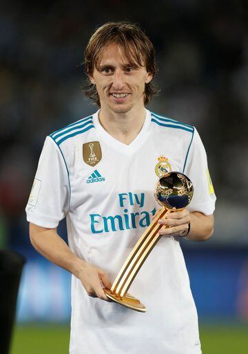 Real Madrid’s Luka Modric celebrates with an award after the match