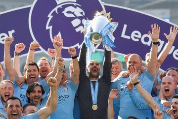 Manchester City manager Pep Guardiola lifts the trophy as they celebrate winning the Premier League