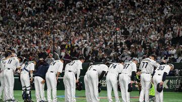 Members of Japan's team bow to thank the crowd at the end of their 9-3 victory in the World Baseball Classic