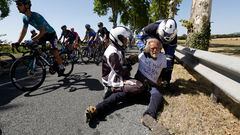 Cycling - Tour de France - Stage 15 - Rodez to Carcassonne - France - July 17, 2022 Police officers remove protestor from the road as riders go by during stage 15 REUTERS/Christian Hartmann