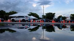 Healthcare workers at a 24-hour drive-thru site set up by Miami-Dade and Nomi Health in Tropical Park administer COVID-19 tests on August 30, 2021 in Miami, Florida.