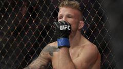 FILE - In this Jan. 20, 2019 file photo, TJ Dillashaw reacts after a flyweight mixed martial arts championship bout against Henry Cejudo at UFC Fight Night in New York.  Dillashaw has surrendered the UFC 135-pound championship because of an &ldquo;adverse finding&rdquo; in his last drug test. Dillashaw posted on social media that he would give up the belt after he was informed by the New York State Athletic Commission and the United States Anti-Doping Agency of the results of his test leading up to his last fight in January.  Dillashaw suffered first-round loss to Henry Cejudo and failed to become a two-division champion. (AP Photo/Frank Franklin II, File)