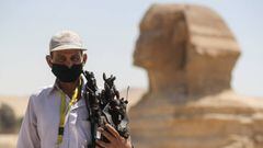 A man wearing a face mask is seen in front of Sphinx at the Great Pyramids of Giza after reopening for tourist visits, following the outbreak of the coronavirus disease (COVID-19), in Cairo, Egypt July 1, 2020. REUTERS/Mohamed Abd El Ghany