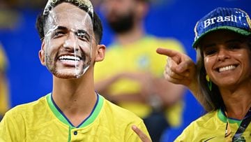 A Brazil supporter wearing a mask of Brazil's forward #10 Neymar waits for the start of the Qatar 2022 World Cup Group G football match between Brazil and Switzerland at Stadium 974 in Doha on November 28, 2022. (Photo by Anne-Christine POUJOULAT / AFP)