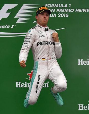 Winner Mercedes AMG Petronas F1 Team's German driver Nico Rosberg (C) celebrates on the podium next to second placed Mercedes AMG Petronas F1 Team's British driver Lewis Hamilton (L) and third placed Scuderia Ferrari's German driver Sebastian Vettel follo