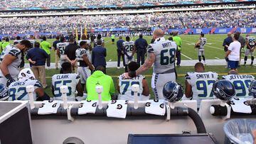 Oct 22, 2017; East Rutherford, NJ, USA; 
 Seattle players sit and kneel on the bench during the National Anthem before the game against the New York Giants at MetLife Stadium. Mandatory Credit: Robert Deutsch-USA TODAY Sports