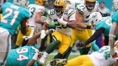MIAMI GARDENS, FLORIDA - DECEMBER 25: AJ Dillon #28 of the Green Bay Packers carries the ball during the second quarter of the game against the Miami Dolphins at Hard Rock Stadium on December 25, 2022 in Miami Gardens, Florida.   Megan Briggs/Getty Images/AFP (Photo by Megan Briggs / GETTY IMAGES NORTH AMERICA / Getty Images via AFP)