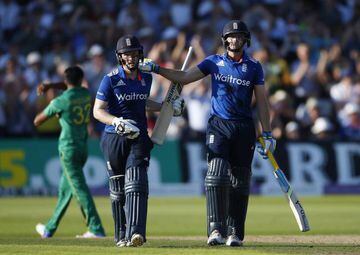England's Jos Buttler and Eoin Morgan celebrate at the end of the innings after breaking the world record.