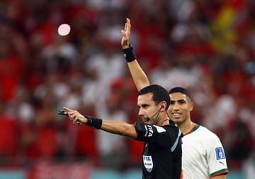Ref Cesar Arturo Ramos in action disallowing a goal from Morocco's Hakim Ziyech after a VAR review.