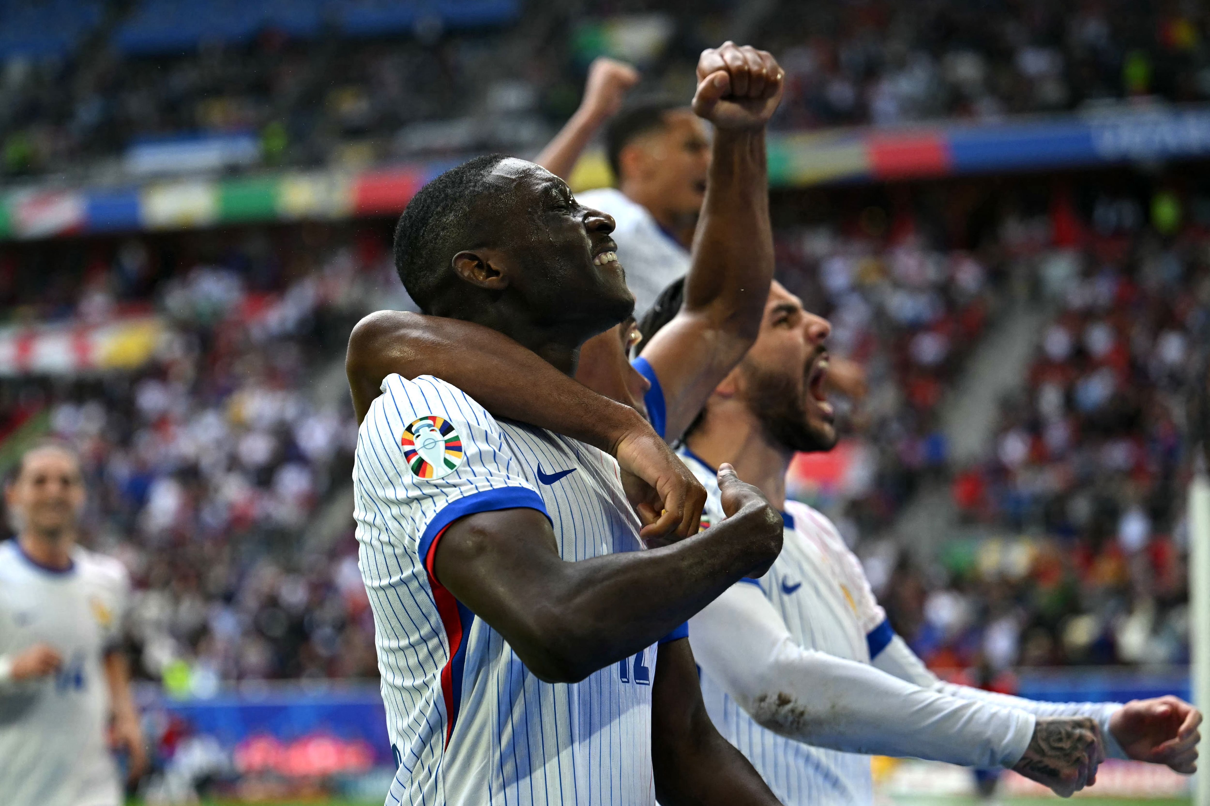 France's forward #12 Randal Kolo Muani (C) celebrates scoring his team's first goal during the UEFA Euro 2024 round of 16 football match between France and Belgium at the Duesseldorf Arena in Duesseldorf on July 1, 2024. (Photo by OZAN KOSE / AFP)