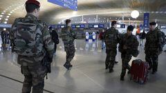 French soldiers patrol inside Charles de Gaulle International Airport. 