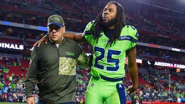 Nov 9, 2017; Glendale, AZ, USA; Seattle Seahawks cornerback Richard Sherman (25) is helped off the field after the game by a coach after rupturing his Achilles tendon against the Arizona Cardinals at University of Phoenix Stadium. Mandatory Credit: Mark J. Rebilas-USA TODAY Sports