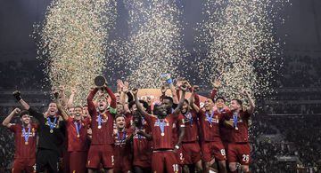 Jordan Henderson of Liverpool lifts the trophy as they celebrate victory following the FIFA Club World Cup Qatar 2019