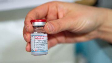 A healthcare professional holds a vial of the Moderna Covid-19 vaccine at the West Wales General Hospital in Carmarthen, Wales, on April 7, 2021. - Britain on April 7 began rolling out its third coronavirus vaccine, from US company Moderna, as questions m