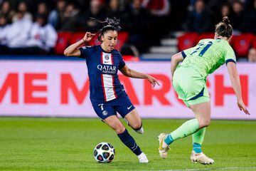 Sakina Karchaoui of Paris Saint-Germain (L) dribbles Alexandra Popp of Wolfsburg 