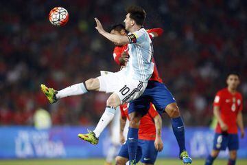 Chile's Gonzalo Jara challenges the returning Lionel Messi during the hard fought qualifier.