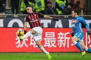 AC Milan's Spanish forward Suso outruns Napoli's Portuguese defender Mario Rui.