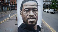 MANCHESTER, UNITED KINGDOM - JUNE 03: Floral tributes lay next to a mural of George Floyd, by street artist Akse, in Manchester&#039;s northern quarter on June 03, 2020 in Manchester, United Kingdom. The death of an African-American man, George Floyd, whi