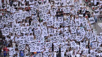 People stand in the grandstands as they hold white placards in tribute to the victims of the Bastille day attack in Nice before the French L1 football match between OGC Nice and Rennes on August 14, 2016, at the Allianz Riviera stadium in Nice, southern France. / AFP PHOTO / Franck PENNANT