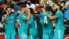 Real Madrid players celebrate their second goal scored by Real Madrid&#039;s French forward Karim Benzema (R) during the Spanish League football match between Valencia CF and Real Madrid CF at the Mestalla stadium in Valencia on September 19, 2021. (Photo