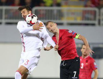 Albania's Ansi Agolli (L) vies with Spain's Gerard Pique (L) during the World Cup 2018 qualifier football match Albania vs Spain in Loro Borici stadium in the city of Shkoder on October 9, 2016. / AFP PHOTO / GENT SHKULLAKU