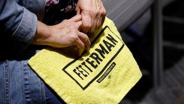 A woman holds a campaign towel at a campaign rally for Pennsylvania Democratic U.S. Senate candidate John Fetterman ahead of the 2022 U.S. midterm election in Pittsburgh, Pennsylvania, U.S. November 7, 2022.  REUTERS/Quinn Glabicki