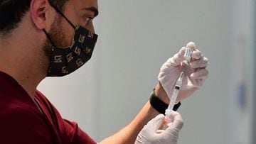 Pharmacy student Norbek Gharbian prepares a Johnson &amp; Johnson Covid19 vaccine on May 7, 2021 in Los Angeles, California, at a vaccination clinic setup by Los Angeles Football Club, partnering with the LA county Department of Public Health and USC Phar